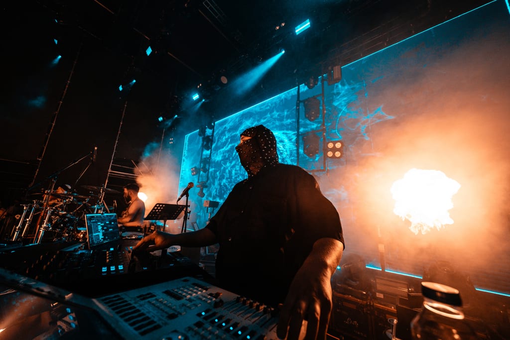 Okan Çam on stage at the console